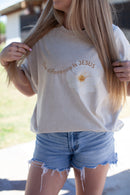 Beige t-shirt, white flower, the difference is jesus