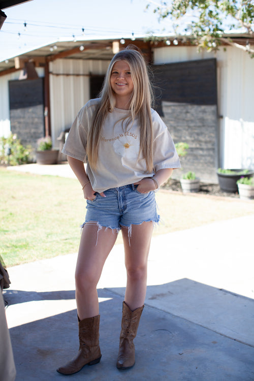 Beige t-shirt, white flower, the difference is jesus