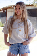Beige t-shirt, white flower, the difference is jesus